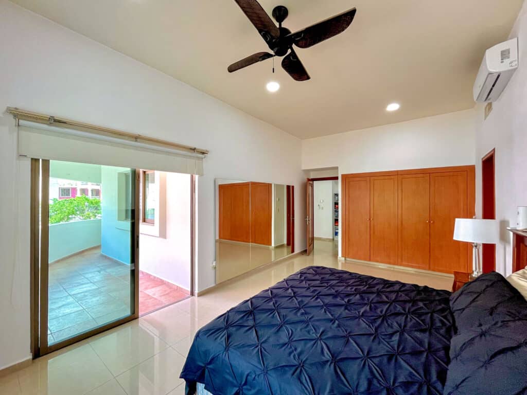 bedroom view with balcony in background